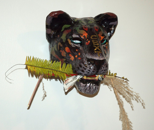 lion with leaves in teeth 